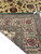 Back of the Tabriz rug folded over, showing tight knotting, clear pattern definition and edge binding