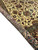 Rolled edge comparing the ivory pile surface with the finely woven reverse of the border