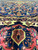 Navy field detail with coral and ivory border cartouche showing a small woven motif