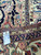Back tag reading Genuine Hand Woven Oriental Rug with size 13.1 x 19.5