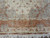 Woven signature cartouche in Persian script below the vase and flower basket main border
