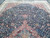 Dense navy floral field with rust pendant and paisley filled spandrels seen from one end