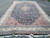 Complete 14' x 24' mansion size rug laid flat in a parking lot with fringe visible