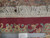 Back of this 13x25 hand-knotted wool rug with ruler and Authentic Handmade tag showing knot rows