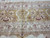 Tortilla brown main border with ivory palmettes, pink lotus blossoms and burgundy outlines close up