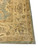 Corner detail showing the golden ivory border meeting the olive green field with scrolling vine motifs