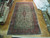 9'8 x 17'5 Persian Kerman rug laid flat on parquet floor in our Freeport warehouse