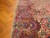 Close-up of indigo main border with rose paisleys, blossoms and soft sage outer guard stripe