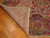 Corner folded back revealing even hand-knotted back and cotton foundation of this oversize 11x17 antique rug