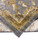 Folded corner revealing the tight hand-knotted back and low 5/16 inch wool pile in taupe tones