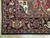 Corner detail showing black main border, red guard stripes, ivory fringe and tight wool weave