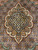 Detail of the ivory and blue medallion core surrounded by copper petals and tiny rosettes