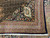 Corner of the black main border with ivory palmette cartouche, rust guard stripes and cotton fringe