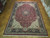 12'1" x 18'1" hand-knotted wool rug displayed on parquet floor showing full medallion layout