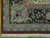 Corner detail showing light blue scrollwork, navy flowering border and hand-finished ivory fringe
