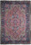 Salmon field Persian Heriz rug with navy floral border and stepped geometric center medallion shown flat