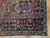 Corner detail of navy main border with flowering plants, camel guard stripe and intact original selvage