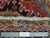 Ruler beside ivory fringe and pile showing authentic hand-knotted wool construction and knot density up close