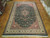 12'2" x 18'7" Pakistani rug shown on parquet floor with full medallion design visible