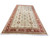 12'7" x 24'2" hand-knotted Indian rug angled to show ivory field and red border