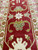 Close-up of the red border with sage palmettes, ivory rosettes and olive vine scrolls