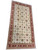 12'7" x 24'2" oversize palace rug upright, dense floral vines across cream wool ground