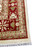 Corner of the rug showing layered borders, ivory outer guard band and white fringe