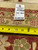 Back tag reading rug number B-78858 with tape measure confirming the width