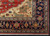 Corner detail showing ivory spandrel, green serrated leaves and navy palmette border on wool