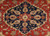 Navy blue stepped medallion with ivory rosette and salmon palmettes on orange red field