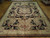 10x14 Sino rug displayed lengthwise, black field with ivory Aubusson border and floral corners