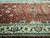 13' x 20'9" Indian wool rug photographed lengthwise, ivory border framing the coral field