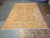Palace size natural wool rug for large living rooms, shown flat under warehouse lighting