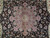 Close-up of rose pink medallion, palmettes and vine scrolls on deep black floral field