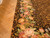 Close up of rose, tulip and grape cluster border beside a herringbone parquet floor