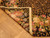 Folded corner revealing the flat needlepoint back and bound selvage of this hand stitched wool rug