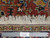 Ruler beside fringe confirms authentic handmade wool weave and knot density of this Heriz rug