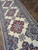 Long hallway runner view down the ivory field with 3 red medallions and navy spandrels