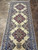 Persian Nain runner top section with 3 star medallions and floral navy border on stone tile