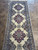 Fine hand-knotted runner showing tight knot detail, ivory pile and multi band blue border