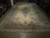 12' x 22' palace size Persian rug laid flat on warehouse floor showing ivory open field