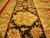 Detail of black border with ivory palmettes, red leaf sprays and sage green vine work