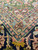 Close-up where rose and sky blue guard stripes meet the navy indigo main border