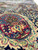Navy border with raspberry rosette medallion and ivory boteh leaf scrolls in close detail