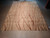 Complete rug from above on the floor, open beige ground at left and clustered lines at right