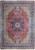 Whole Persian Tabriz rug flat: red field, navy medallion, ivory spandrels, wide cobalt blue floral border
