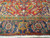 End border of vintage Heriz rug: indigo ground, rose palmettes, gold blossom, ivory fringe