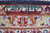Border detail showing a woven inscription cartouche above a pale blue guard stripe with palmettes