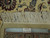 Reverse edge and fringe photographed with a ruler and an Authentic Hand Knotted label for scale