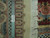 Ruler laid across the border stripes beside the white fringe, showing pile and hand-knotted construction